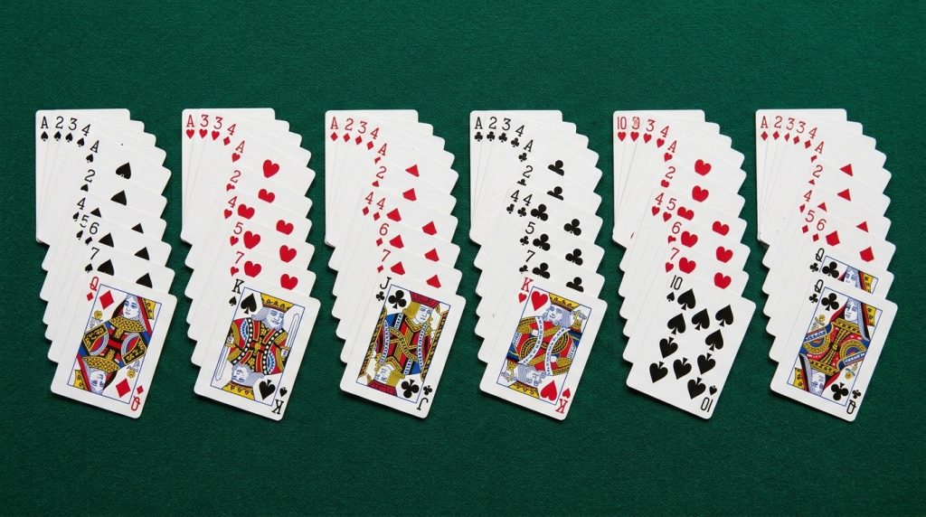Six fanned stacks of playing cards with the ten-value cards pulled out