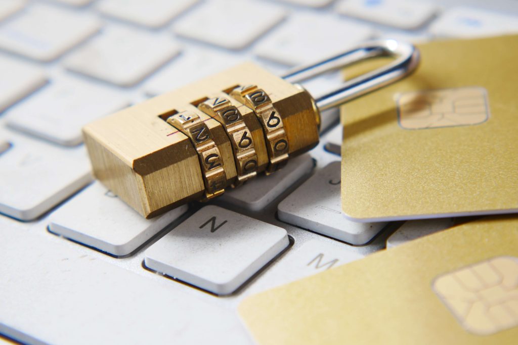 A padlock sitting on top of a white keyboard.